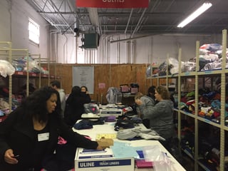 Team members from ECBM volunteer at Cradles to Crayons for the IICF Week of Giving 2017